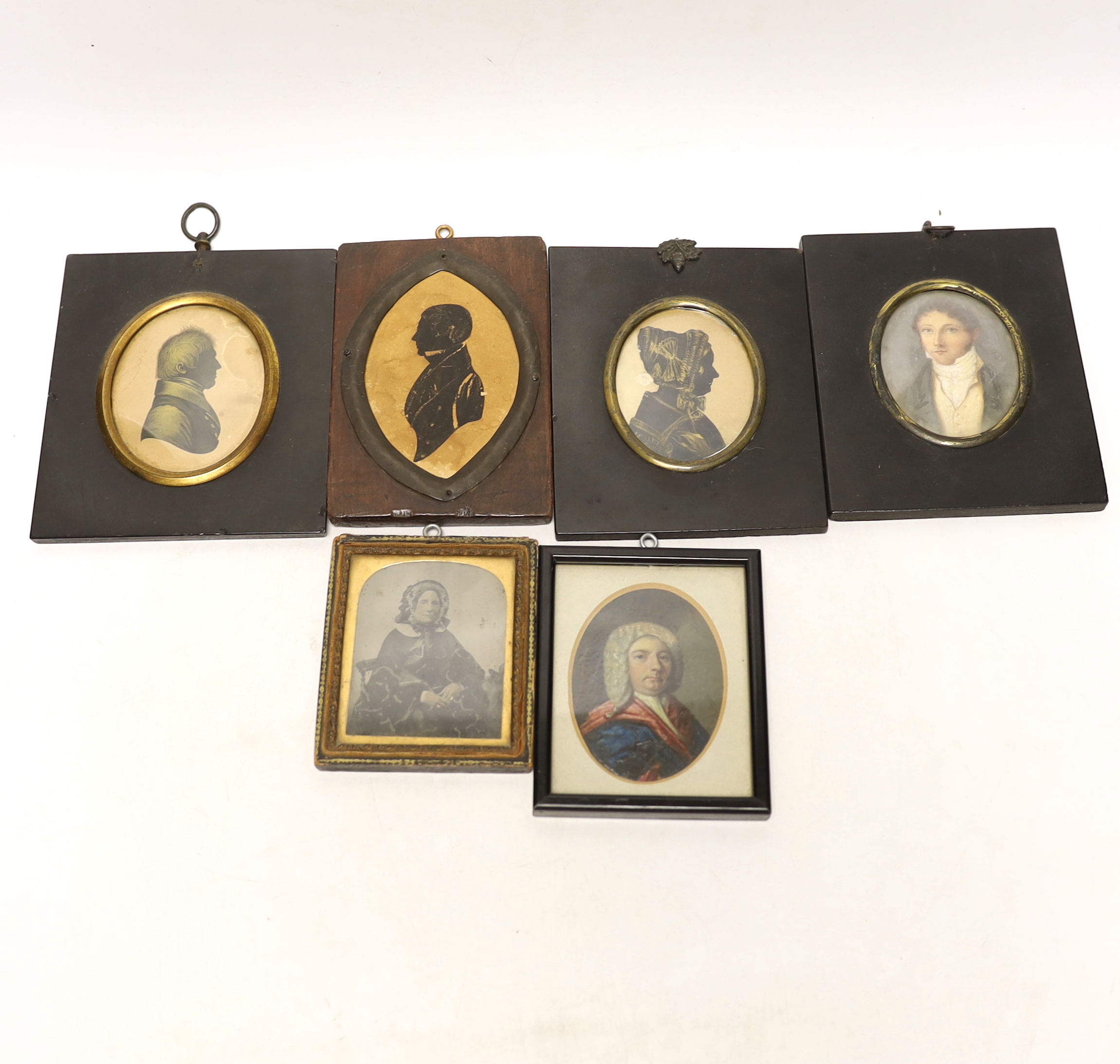 A quantity of miniatures comprising oil of an 18th century gentleman wearing a wig, three 19th century silhouettes, Victorian blue and white photograph and one other